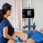 Physician using Kosmos Torso-One to scan DVT