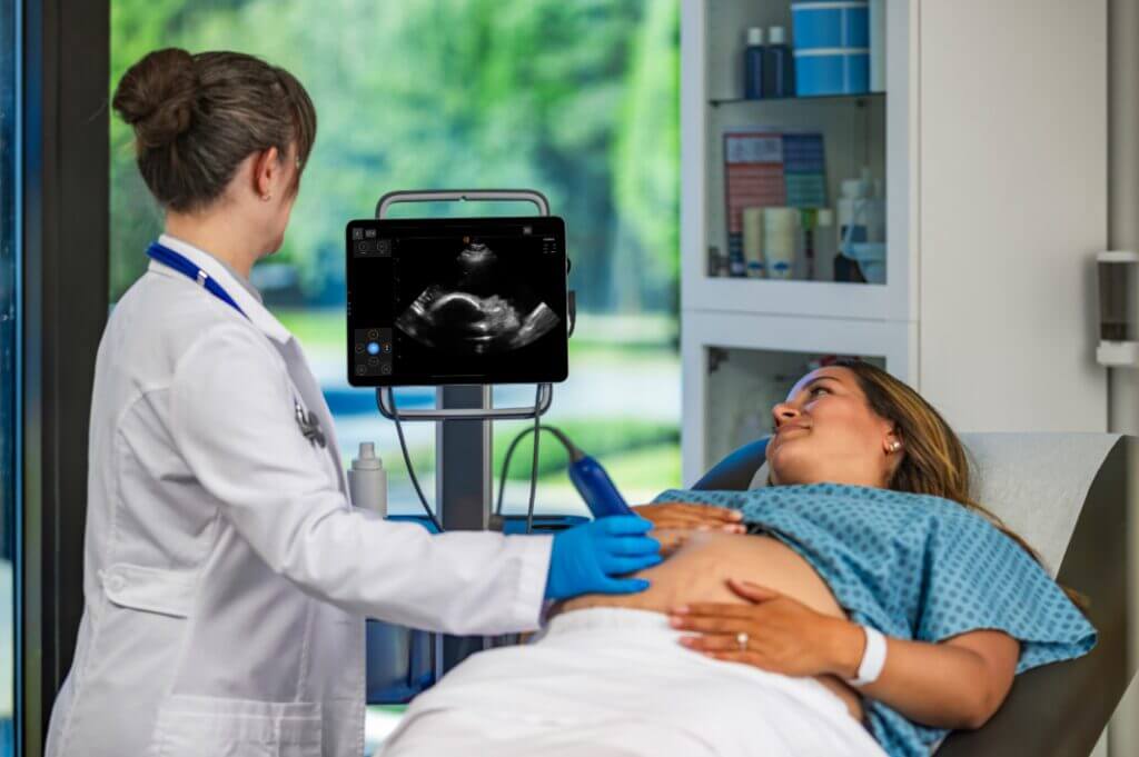 physician using Kosmos to ultrasound baby