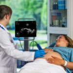 physician using Kosmos to ultrasound baby
